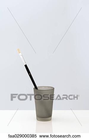 Stock Photography - Paintbrush in cup, close-up. Fotosearch