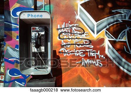 Pay phone on grafitti-covered wall View Large Photo Image Stock Photo - Pay phone on grafitti-covered wall. Fotosearch