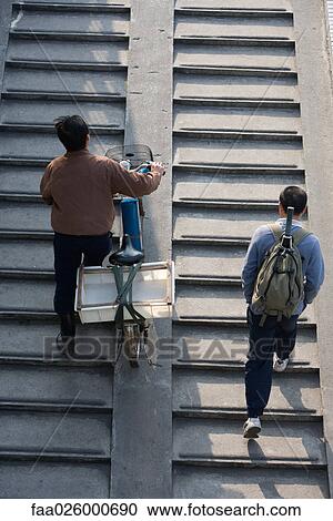 Pedestrians walking up steps, one pushing bicycle, viewed from directly above View Large Photo Image Stock Image - Pedestrians walking up steps, one pushing bicycle, viewed from directly above. Fotosearch