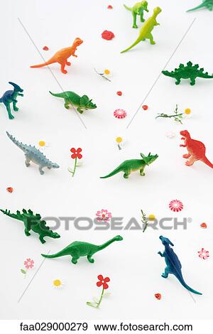 Plastic dinosaurs surrounded by fake flowers, high angle view View Large Photo Image Stock Photo - Plastic dinosaurs surrounded by fake flowers, high angle view. Fotosearch