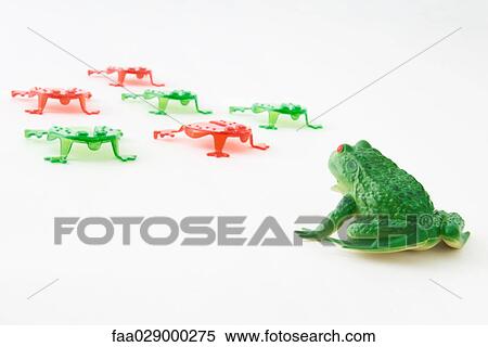 Plastic frog facing group of frog shaped game pieces View Large Photo Image Stock Photography - Plastic frog facing group of frog shaped game pieces. Fotosearch