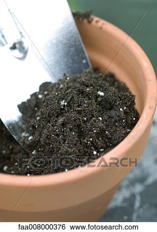 Pot full of soil and trowel View Large Photo Image Stock Photograph - Pot full of soil and trowel. Fotosearch