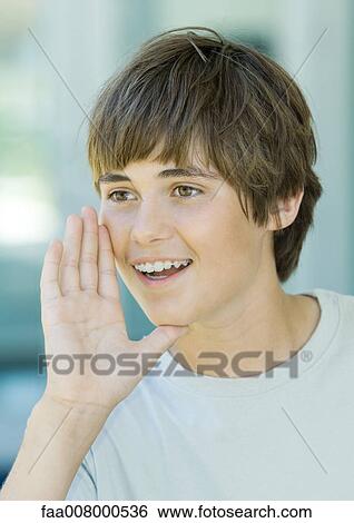 Preteen boy holding hand by mouth, yelling View Large Photo Image Stock Photograph - Preteen boy holding hand by mouth, yelling. Fotosearch