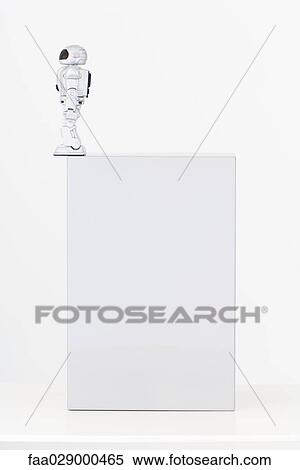Stock Photography - Robot standing on edge of box. Fotosearch