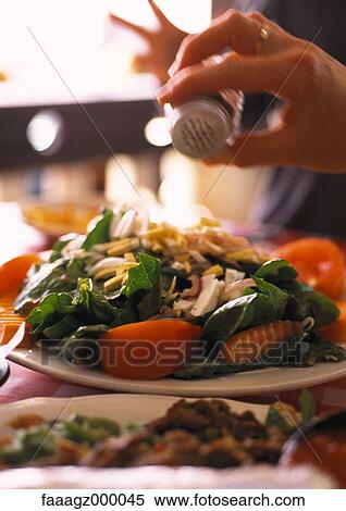 Salting a salad View Large Photo Image Stock Photography - Salting a salad. Fotosearch