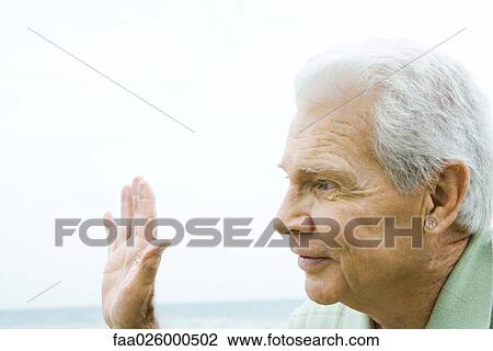 Senior man waving hand, smiling, side view View Large Photo Image Stock Image - Senior man waving hand, smiling, side view. Fotosearch