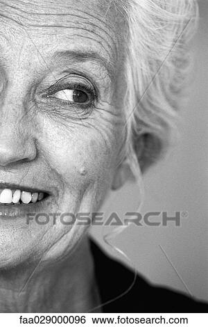 Stock Photograph - Senior woman looking away and smiling, portrait, cropped. Fotosearch