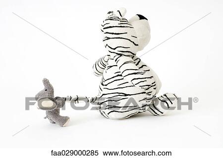 Stock Photography - Stuffed toys, elephant pulling tiger's tail. Fotosearch