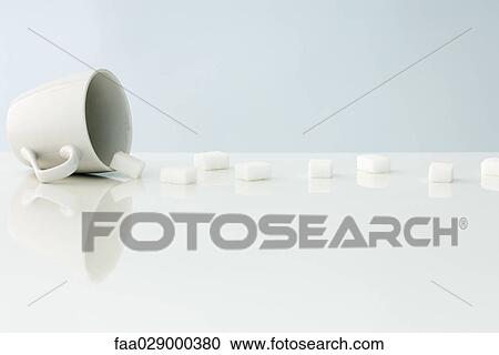 Sugar cubes spilling out of mug View Large Photo Image Stock Image - Sugar cubes spilling out of mug. Fotosearch