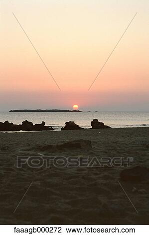 Stock Image - Sunrise at beach. Fotosearch