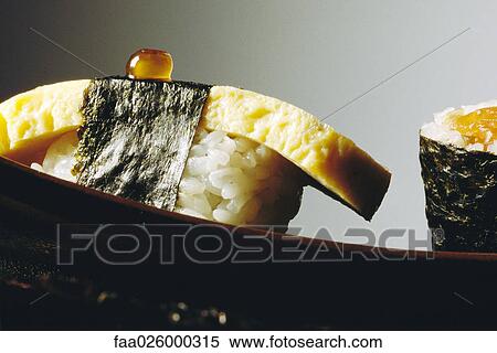 Tamago sushi with fish roe, extreme close-up View Large Photo Image Stock Photography - Tamago sushi with fish roe, extreme close-up. Fotosearch