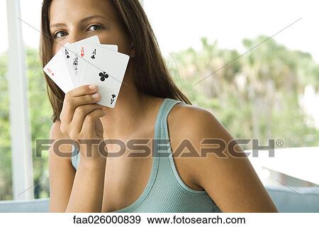 Teenage girl holding cards in front of face, all aces, looking at camera View Large Photo Image Stock Photo - Teenage girl holding cards in front of face, all aces, looking at camera. Fotosearch
