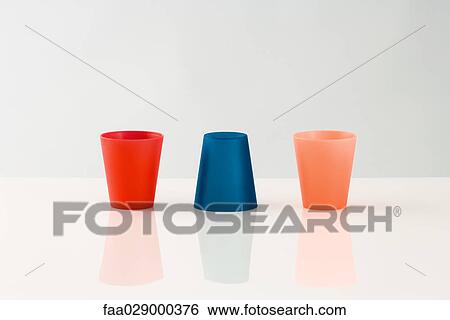 Three colored cups View Large Photo Image Stock Photograph - Three colored cups. Fotosearch