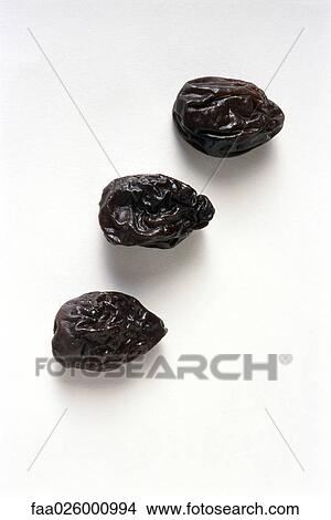 Three prunes, close-up View Large Photo Image Picture - Three prunes, close-up. Fotosearch