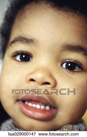 Toddler boy smiling at camera, close-up, portrait View Large Photo Image Stock Photo - Toddler boy smiling at camera, close-up, portrait. Fotosearch