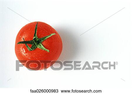 Stock Image - Tomato with droplets of water, close-up, viewed from directly above. Fotosearch