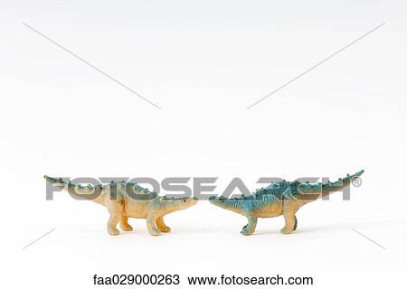 Toy dinosaurs facing each other View Large Photo Image Stock Image - Toy dinosaurs facing each other. Fotosearch