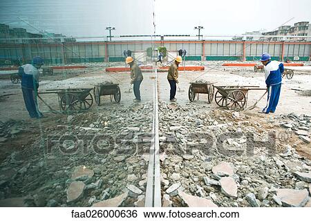 Two construction workers digging on construction site View Large Photo Image Stock Photograph - Two construction workers digging on construction site. Fotosearch