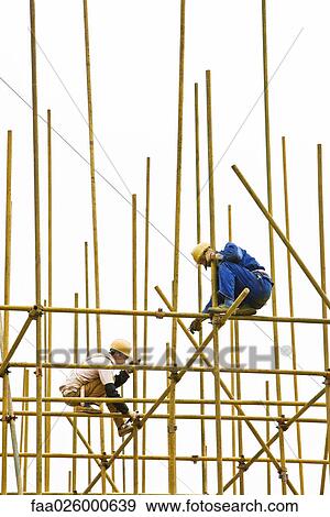 Two construction workers putting together scaffolding View Large Photo Image Stock Photo - Two construction workers putting together scaffolding. Fotosearch