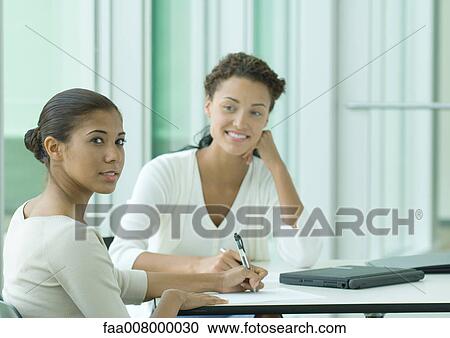 Two female office workers View Large Photo Image Stock Image - Two female office workers. Fotosearch