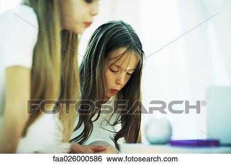 Two girls bending over candles, puckering lips, cropped view View Large Photo Image Stock Photograph - Two girls bending over candles, puckering lips, cropped view. Fotosearch