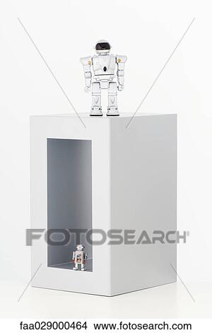 Two robots, one inside box, the other on top of box View Large Photo Image Picture - Two robots, one inside box, the other on top of box. Fotosearch