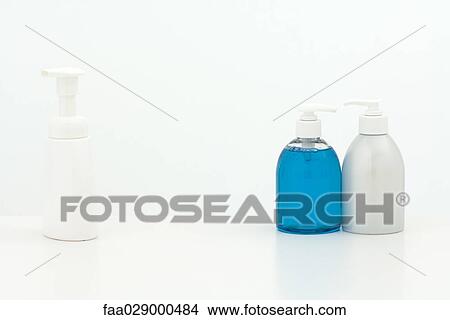 Two soap dispensers face to face while one stands alone View Large Photo Image Picture - Two soap dispensers face to face while one stands alone. Fotosearch