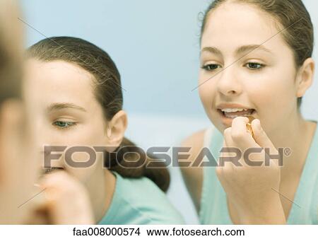 Two teenage girls putting on make-up View Large Photo Image Picture - Two teenage girls putting on make-up. Fotosearch