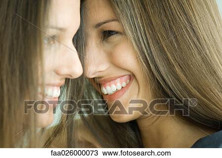 Two twin teenage sisters smiling, face to face, profile View Large Photo Image Stock Image - Two twin teenage sisters smiling, face to face, profile. Fotosearch