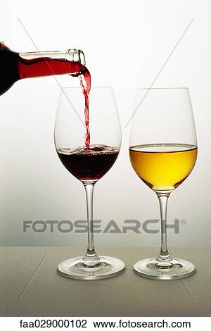 Two wine glasses, red wine being poured into one, white wine in the other View Large Photo Image Stock Image - Two wine glasses, red wine being poured into one, white wine in the other. Fotosearch
