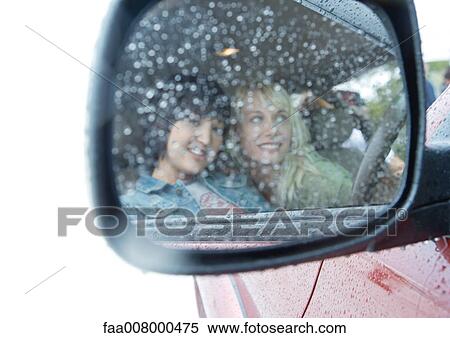 Two women reflected in side-view mirror View Large Photo Image Stock Photography - Two women reflected in side-view mirror. Fotosearch