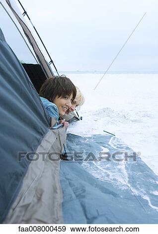 Two women sticking heads out of tent on beach View Large Photo Image Stock Photo - Two women sticking heads out of tent on beach. Fotosearch