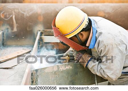 Welder working, side view View Large Photo Image Stock Photograph - Welder working, side view. Fotosearch