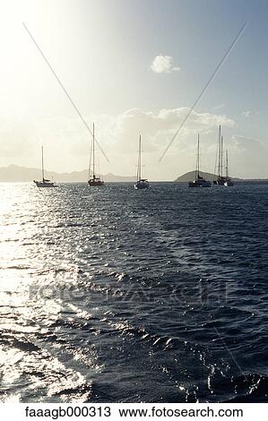 Stock Image - West Indies, Grenadines, Tobago Cays, sail boats at sea. Fotosearch