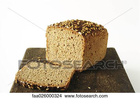 Whole wheat bread loaf and slice on cutting board View Large Photo Image Picture - Whole wheat bread loaf and slice on cutting board. Fotosearch