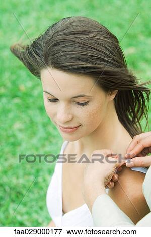 Woman adjusting teen girl's shoulder strap, high angle view, cropped View Large Photo Image Stock Photo - Woman adjusting teen girl's shoulder strap, high angle view, cropped. Fotosearch
