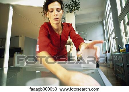 Woman cleaning table View Large Photo Image Stock Image - Woman cleaning table. Fotosearch