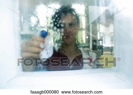 Woman cleaning window View Large Photo Image Stock Image - Woman cleaning window. Fotosearch