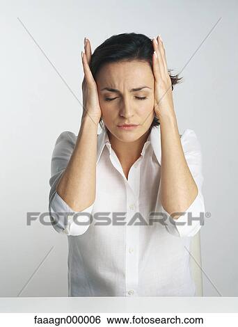 Stock Photograph - Woman covering ears, portrait. Fotosearch