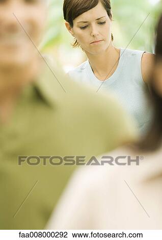 Woman frowning in background View Large Photo Image Stock Image - Woman frowning in background. Fotosearch