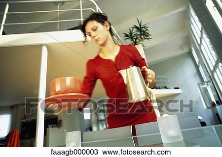 Woman holding coffee pot and cup View Large Photo Image Stock Image - Woman holding coffee pot and cup. Fotosearch