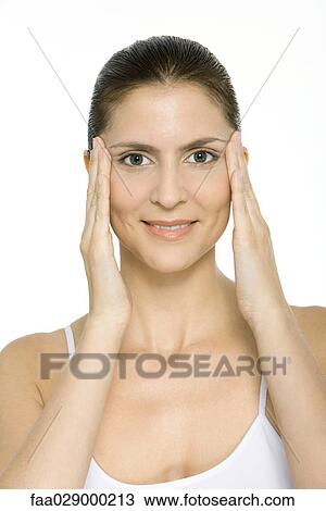 Woman holding face in hands, smiling at camera, portrait View Large Photo Image Stock Image - Woman holding face in hands, smiling at camera, portrait. Fotosearch