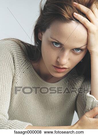 Woman holding head, portrait View Large Photo Image Stock Photo - Woman holding head, portrait. Fotosearch
