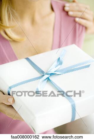 Woman holding present View Large Photo Image Stock Image - Woman holding present. Fotosearch