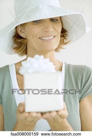 Woman holding present View Large Photo Image Stock Photo - Woman holding present. Fotosearch