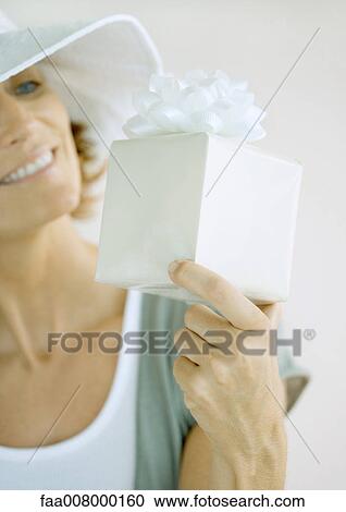Woman holding up present View Large Photo Image Stock Image - Woman holding up present. Fotosearch