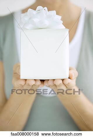 Woman holding up present View Large Photo Image Stock Photo - Woman holding up present. Fotosearch