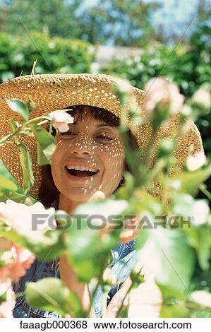 Woman in rose garden View Large Photo Image Stock Photo - Woman in rose garden. Fotosearch