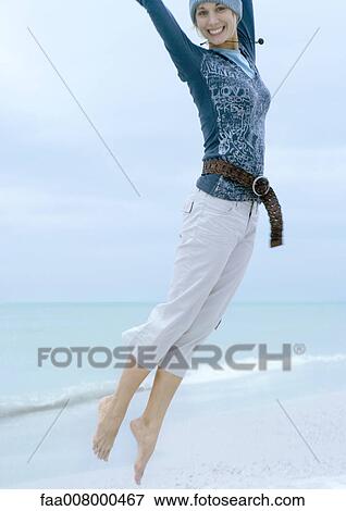 Woman jumping on beach View Large Photo Image Stock Photo - Woman jumping on beach. Fotosearch