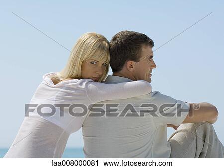 Woman leaning against man, sea in background View Large Photo Image Stock Image - Woman leaning against man, sea in background. Fotosearch